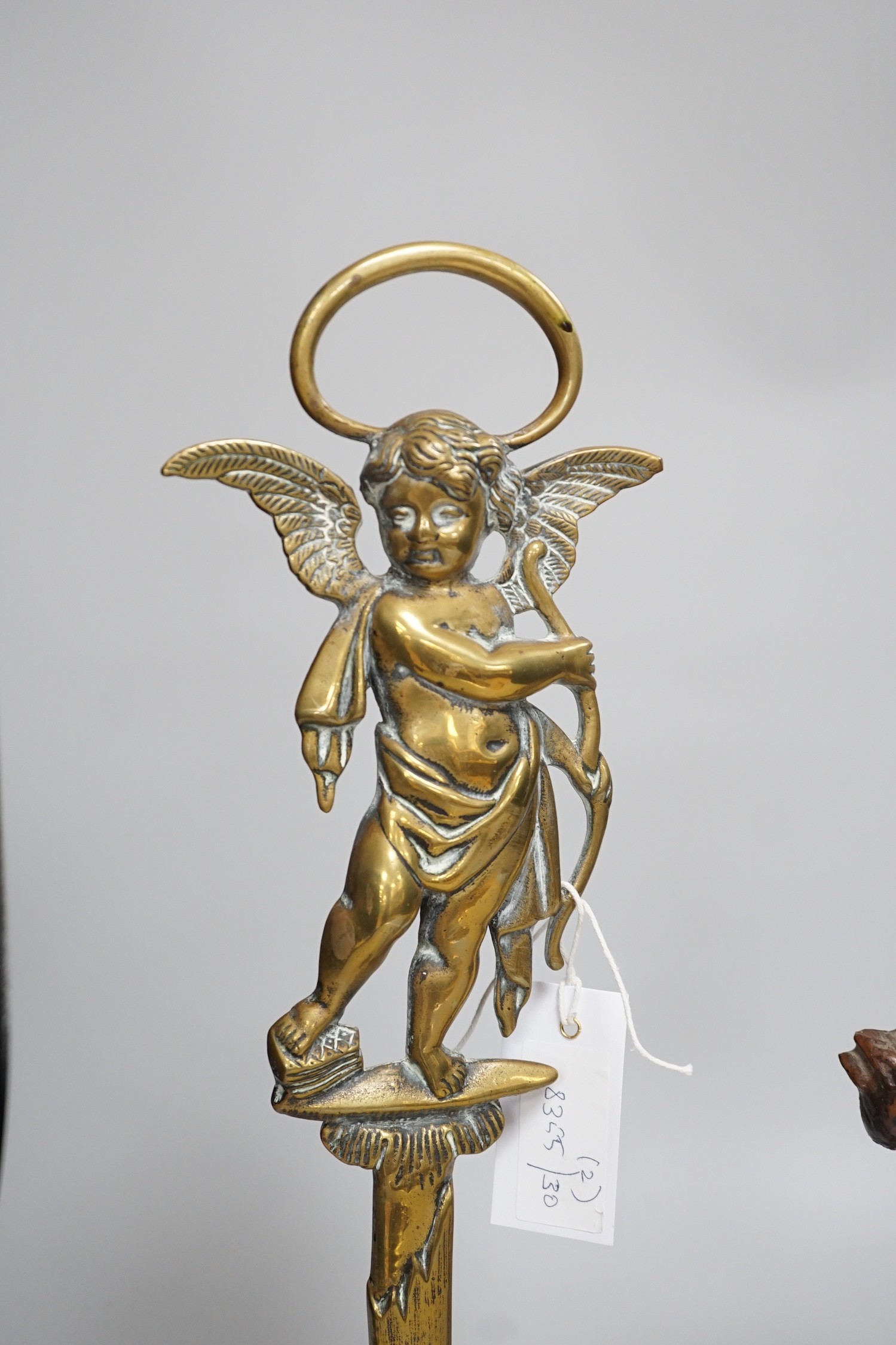 A Victorian bronze cherubic door stop, 45cm, and another painted equine door stop